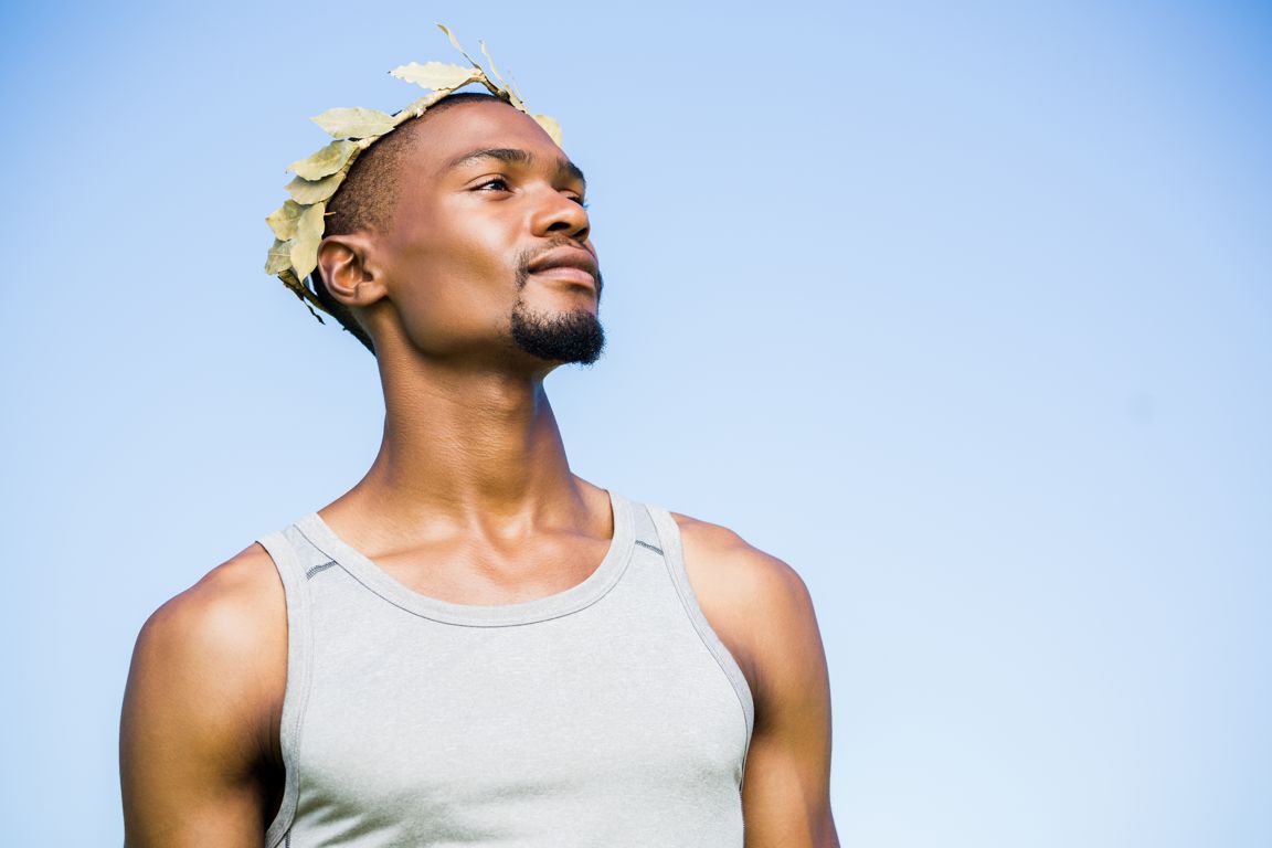 Confident athlete wearing wreath on a sunny day