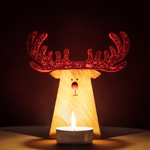 Reindeer Christmas Decoration lit by a candle